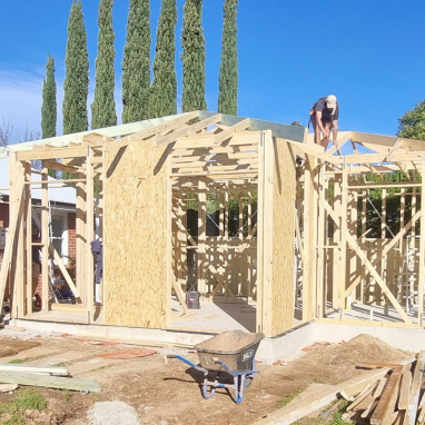 Builder working on roof of new build structure