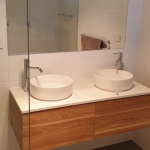 Double sink area with wooden vanity