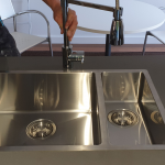 Stainless steel sink with modern tap